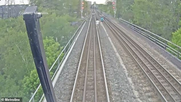Moment three kids dodge death after ‘trying to RACE a train’ while playing on Toronto bridge