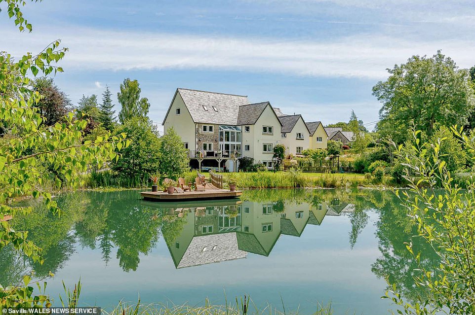 Six-bedroom home with its own WILD SWIMMING lake and pontoon bridge hits the market for £750,000