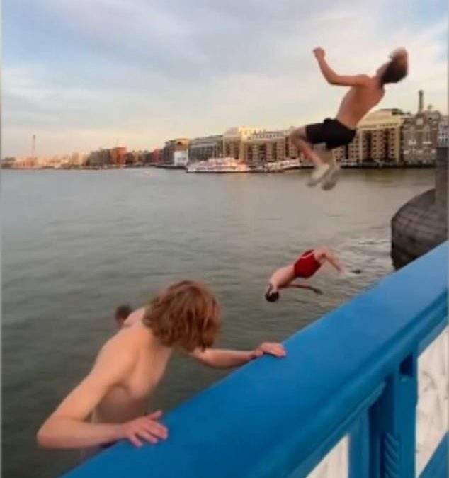 Tower Bridge daredevils risk their lives as they backflip off central London landmark into Thames