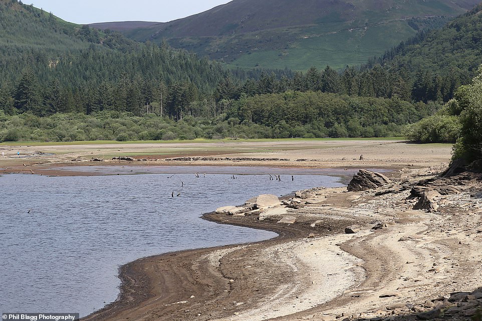 Underwater village hidden beneath Lake Vyrnwy in Wales is revealed due to weeks of dry weather