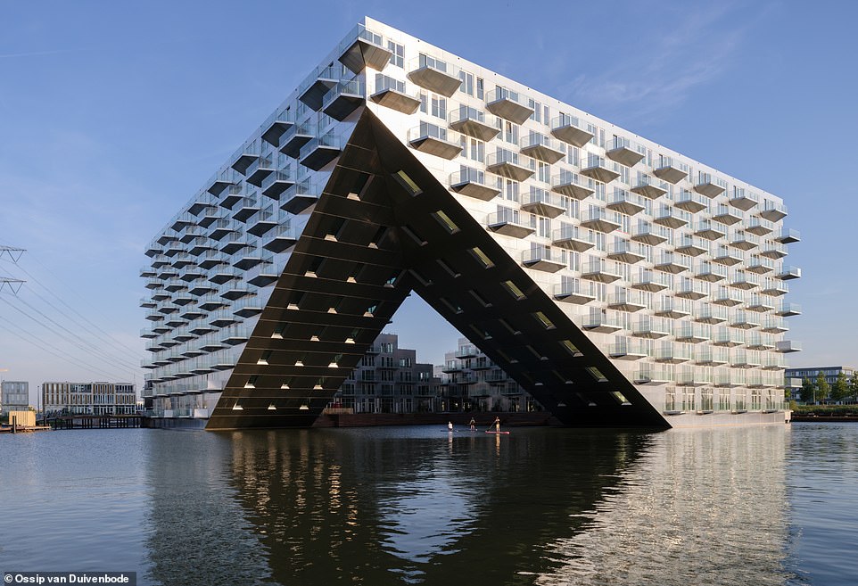 New ship-shaped apartment block in Amsterdam creates the illusion that it’s floating on water 