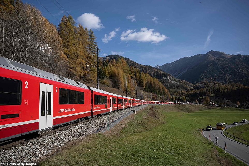 Pictured: World’s longest passenger train winds through the Swiss alps