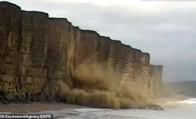 Dramatic moment 1,000 tons of ancient rock falls from 150ft sandstone cliffs on Jurassic Coast