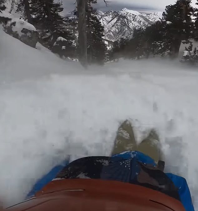 Heart-stopping video shows moment snowboarder slides down mountain while trapped in avalanche