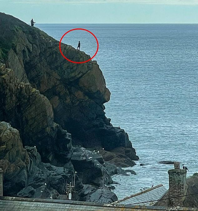 Reckless tourists pose for selfies on the edge of 500ft cliff in Cornwall