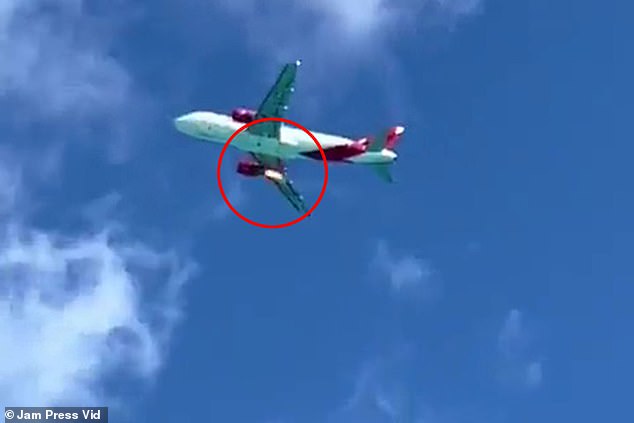 Terrifying moment passenger jet engine bursts into flames above tourist-packed beach