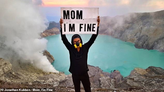 Hilarious photos show globetrotter holding ‘Mom, I’m fine’ sign to assure his mother while ice climbing and swimming with sharks (and next he wants to send his message from space)