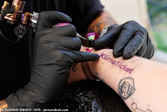 Would YOU turn your body into a billboard? Austrian festivalgoers received permanent tattoos advertising a public transport pass – in return for a year’s worth of free travel