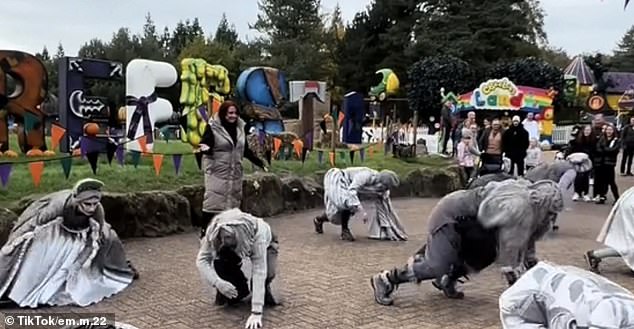Hilarious moment passer-by gets caught in the middle of flash mob at Alton Towers – and steals the show as she tries to keep up