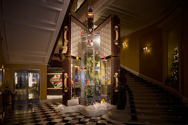 Tis the season to be… flamboyant: Claridge’s hotel unveils its Christmas tree – a dazzling sculpture by Louis Vuitton made from chrome trunks