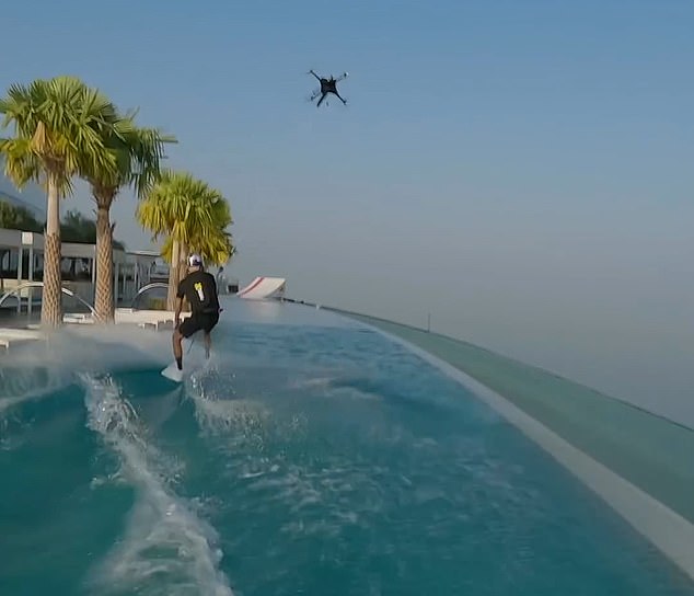 Moment daredevil wakeskates along an infinity pool as he is towed by a drone… what happens next is jaw-dropping
