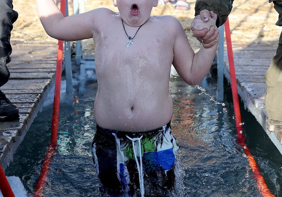 Brave Orthodox Christians plunge into icy water for Epiphany celebrations across Europe despite temperatures as low as -41C