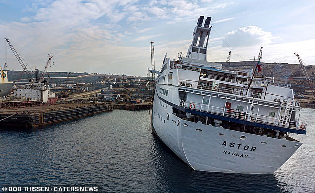 Inside a real live ghost ship: Extraordinary pictures of massive vessel captured by explorers before it was sent to the scrap heap show luxury boat in eery light