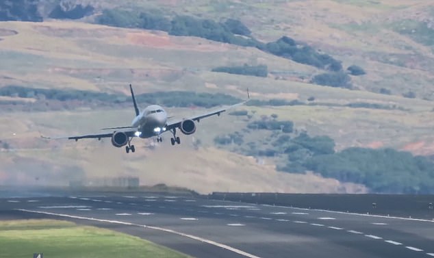 Terrifying moment sparks fly as Scandinavian Airlines jet carrying 90 slams into a runway on holiday island before aborting its landing after suffering engine problems in high winds