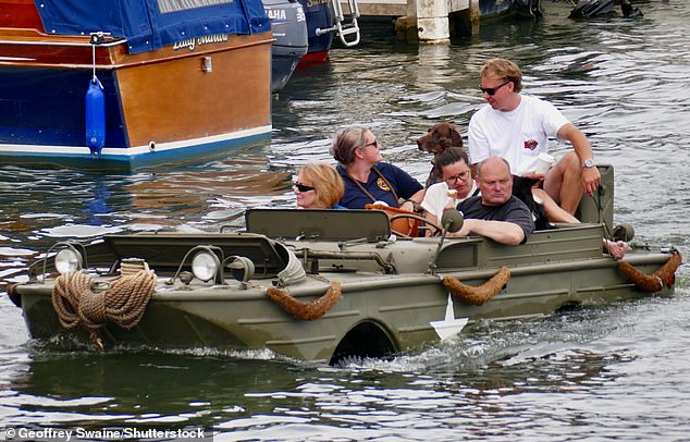 I’ve got a sinking feeling we’re not meant to be here! Vintage amphibious cars take to the Thames for annual Traditional Boat Festival