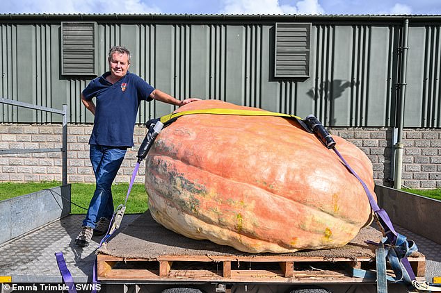 Smashing pumpkin! Twins’ monster veg weighing 188 stone sets new British record after they had to use a crane to get it to country show