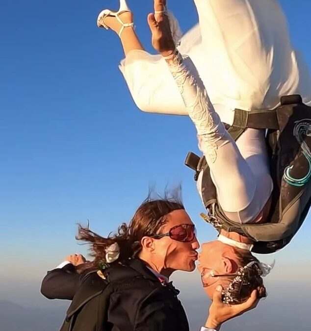 Stunning moment woman dubbed the ‘world’s sexiest skydiver’ ties the knot with her husband, 38, during daring parachute jump